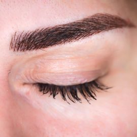 Microblading eyebrows, getting facial care and tattoo at beauty salon
